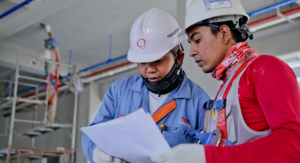 two constructio workers with document